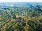 Air Flying Landscape Rural Habitat Air flying birds eye view of rural habitat homes in thousand hills terrain landscape .