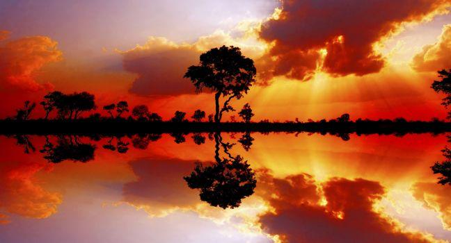 Beautiful African sunset reflected in water, in the Kruger National Park, South Africa; 