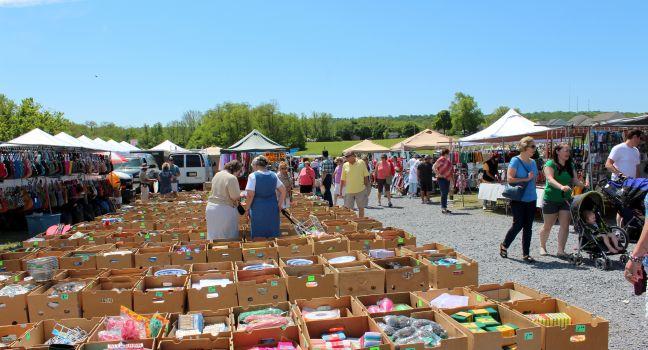 Shoppers wandering the pathways, rummaging through vendors interesting sale items at The Green Dragon farmers market,Ephrata,Pennsylvania,May,2013.