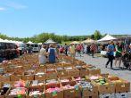 Shoppers wandering the pathways, rummaging through vendors interesting sale items at The Green Dragon farmers market,Ephrata,Pennsylvania,May,2013.