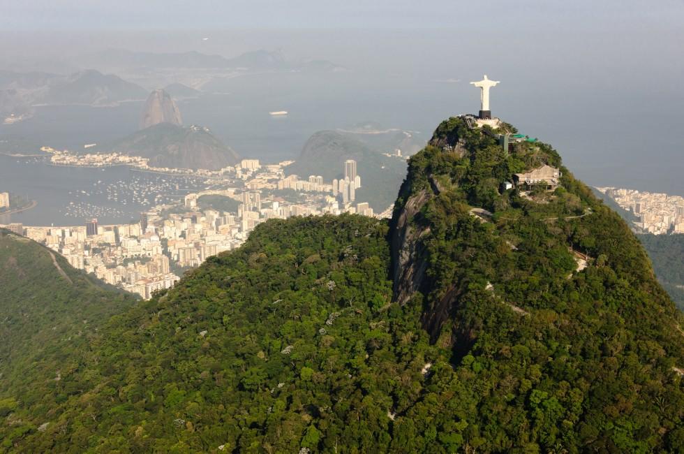 Panorama view from helicopter to rio de janiero with corcovado in front an sugarloaf mountain in the back. picture was taken on a foggy and sunny afternoon in november