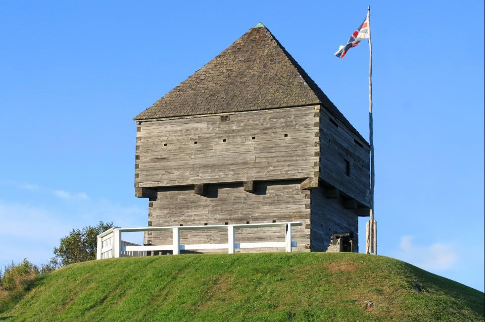 Fort Howe, the site of an 18th and 19th century British Army fortification on a hill in Saint John, New Brunswick, Canada surrounded by blue sky with waving flag; 