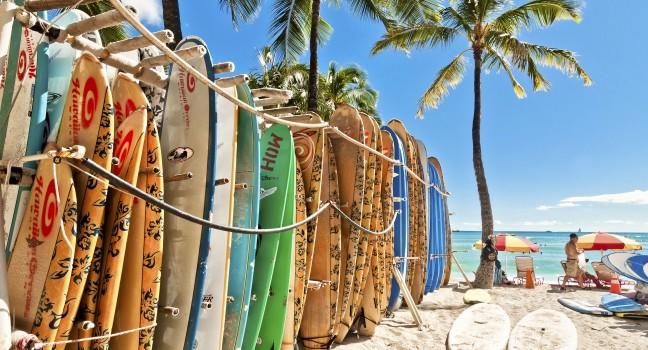 HONOLULU, HAWAII - SEPTEMBER 7, 2013: Surfboards lined up in the rack at famous Waikiki Beach in Honolulu. Oahu, Hawaii.