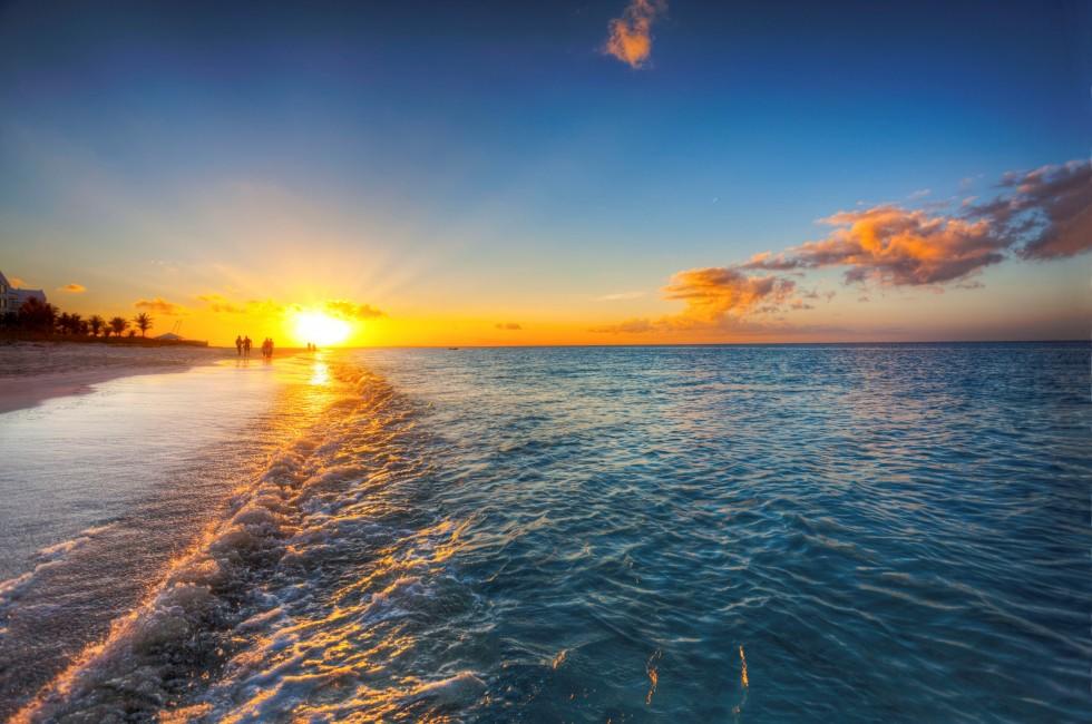 Grace Bay Beach, Turks & Caicos, with the setting sun at the horizon.
