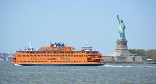NEW YORK CITY, USA - May 26, 2014: Staten Island Ferry passing the Statue of Liberty in  New York Harbor. ; Shutterstock ID 195164825; Project/Title: 25; Downloader: Fodors Travel