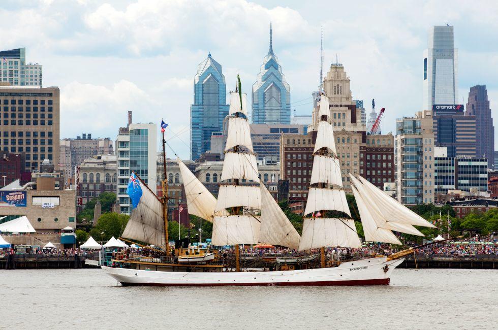 Picton Castle, a 179’ long, 284-ton, three-masted barque sails in front of the Independence Seaport Museum (formerly the Philadelphia Maritime Museum) in the Penn's Landing complex along the Delaware River during Parade of Sails as part of Tall Ship