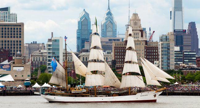 Picton Castle, a 179’ long, 284-ton, three-masted barque sails in front of the Independence Seaport Museum (formerly the Philadelphia Maritime Museum) in the Penn's Landing complex along the Delaware River during Parade of Sails as part of Tall Ship