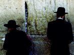Facing eight-ton meleke limestone blocks that comprise the sacred Wailing Wall, a remnant of King David's First Temple, Chasidic Jews recite Amidah at heaven's gate.