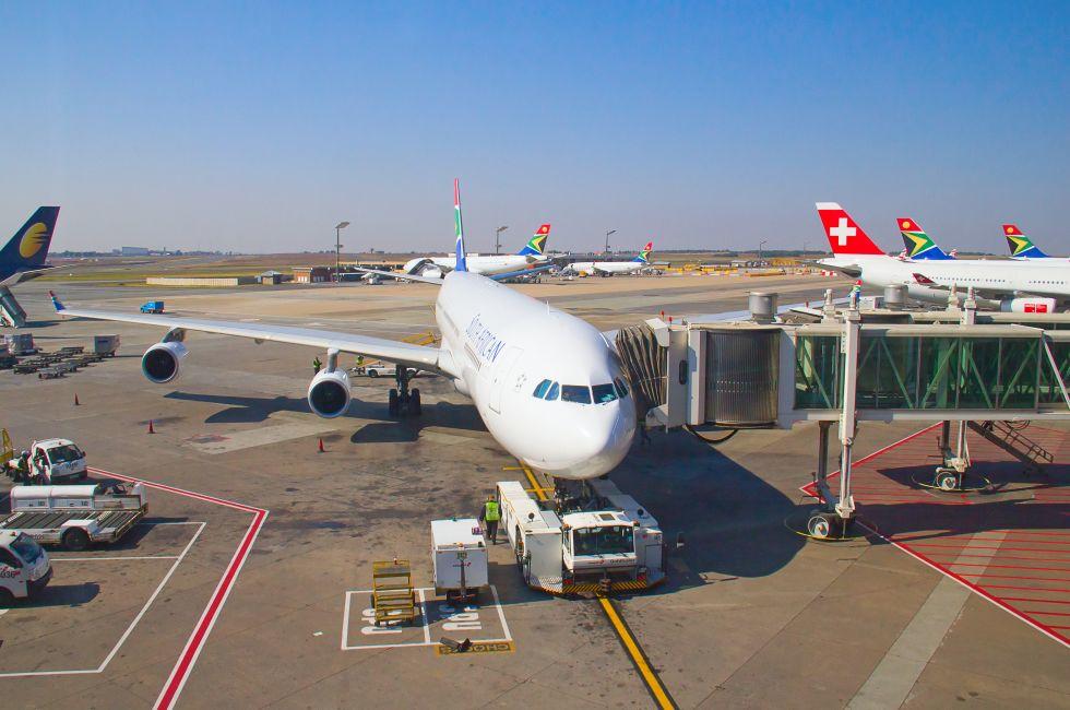 JOHANNESBURG - APRIL 18:Airbus A340 disembarking passengers after intercontinental flights on April 18, 2012 in Johannesburg, South Africa. Johannesburg Tambo airport is the busiest airport in Africa